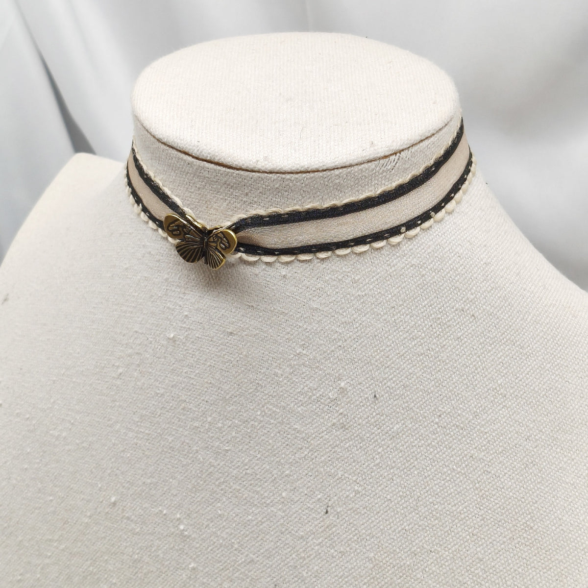 Butterfly ribbon choker with antique bronze butterfly charm on mannequin