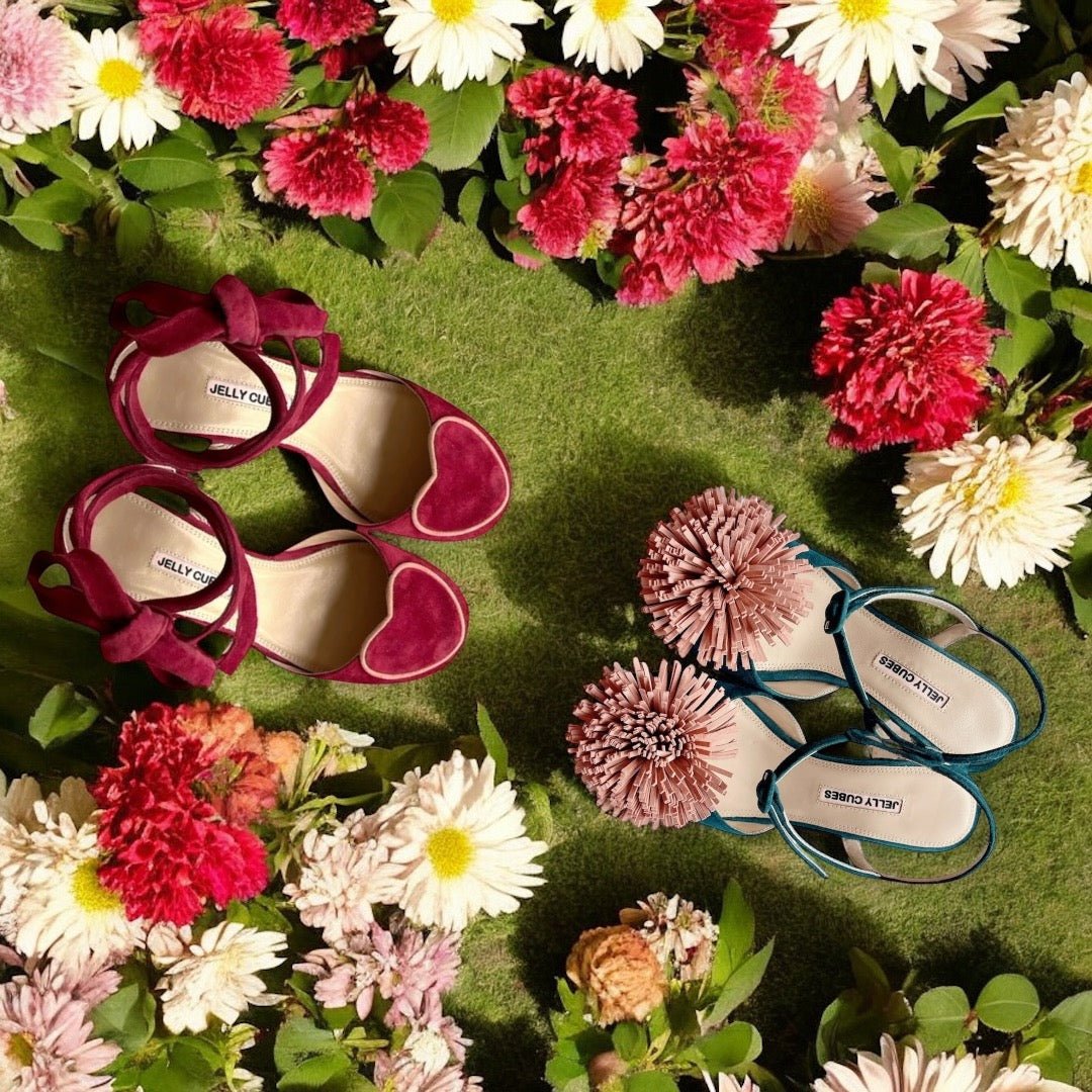 Red love hear t shoes and pom pom shoes surrounded in colourful flowers