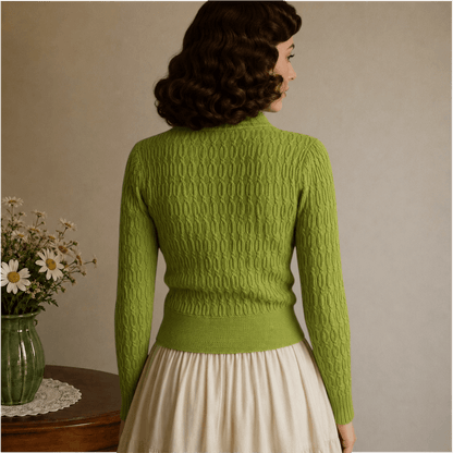 Woman wearing a green chunky cable knitted cardigan back view, vintage style with knit covered buttons 
