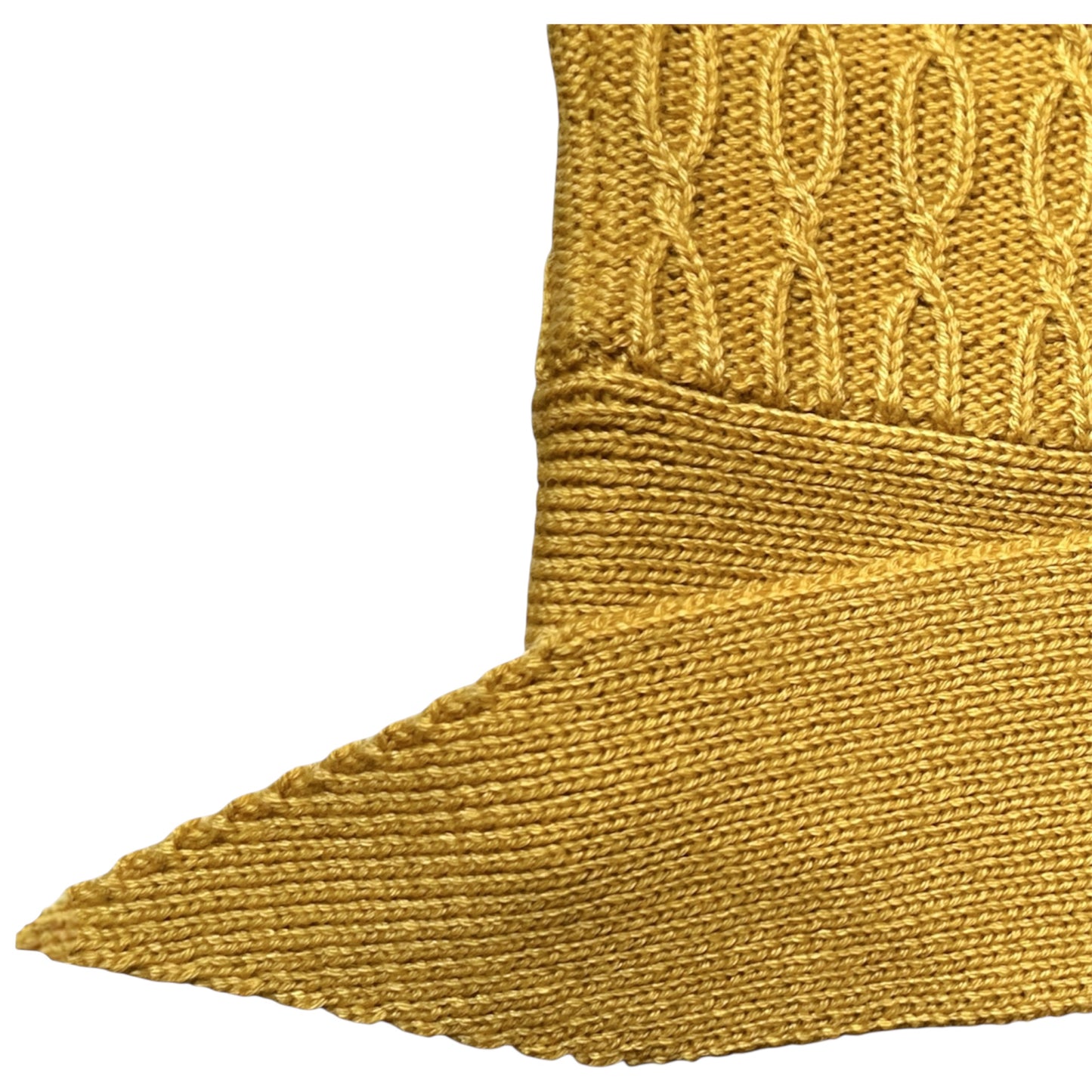 Close-up of a mustard yellow chunky cable knit 