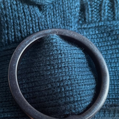 Metallic ring on a textured blue fabric background