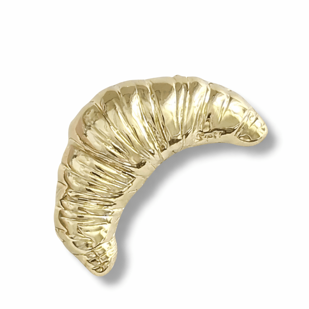 Gold crescent croissant brooch on a white background