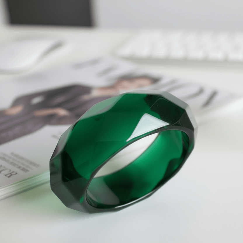 Green  Perspex transparent bangle  next to a fashion magazine 