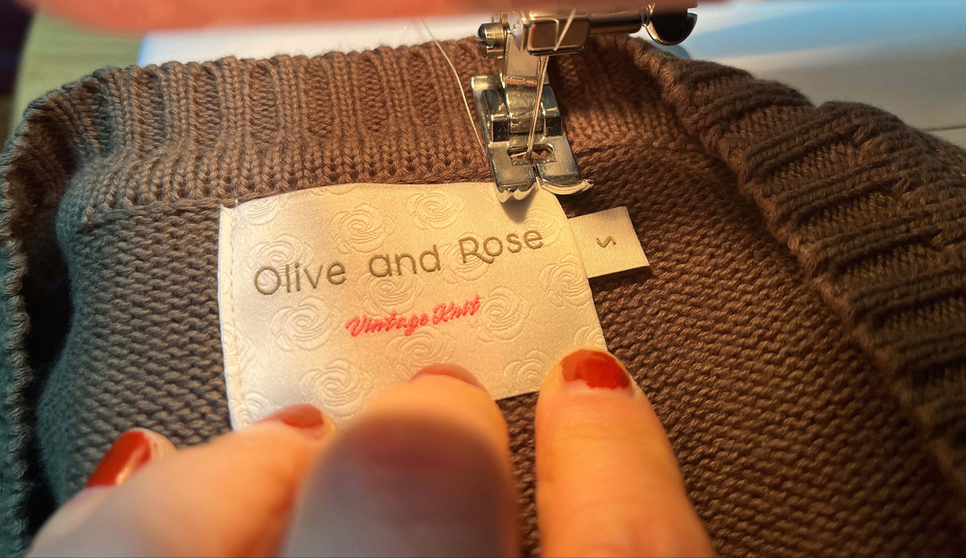 Sewing a label on a  top with a sewing machine. 