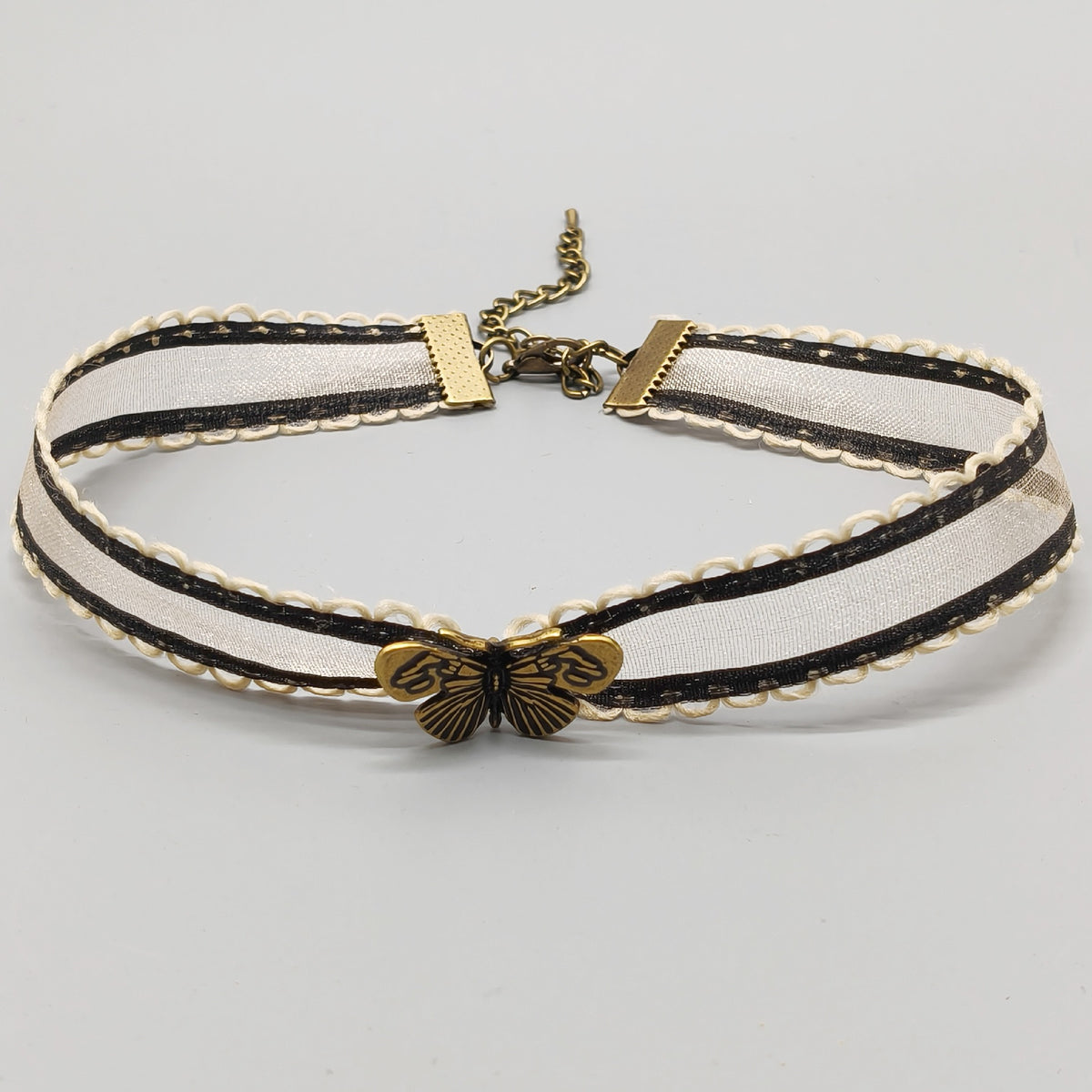 Ivory organza ribbon choker with antique bronze butterfly charm