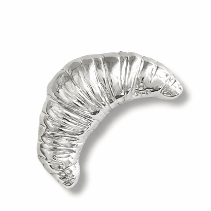 Silver crescent croissant brooch on a white background, vintage style