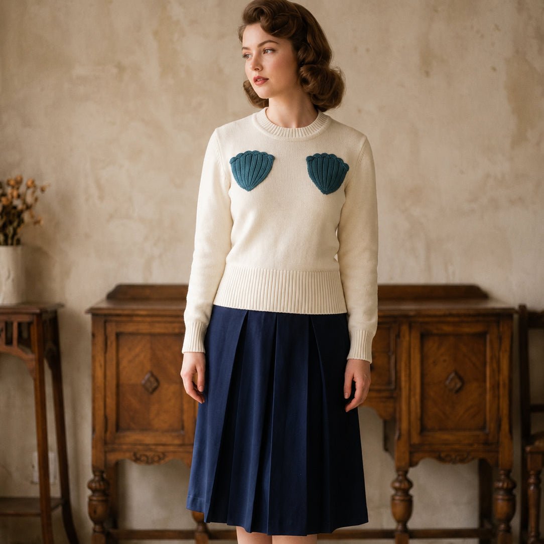 Woman in Ivory cotton jumper with turquoise shell appliqué, vintage styled 