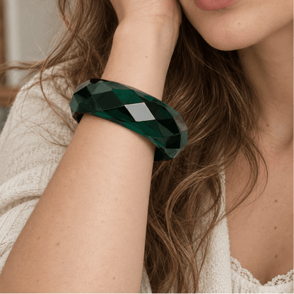Woman wearing a green translucent bangle on her wrist 