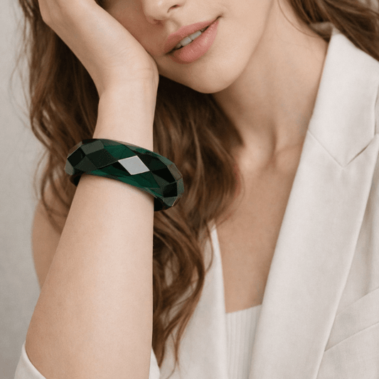 Woman wearing a green translucent bangle on her wrist 