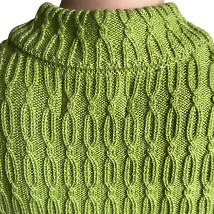 Back view Close-up of a green knitted cardigan with a textured pattern 