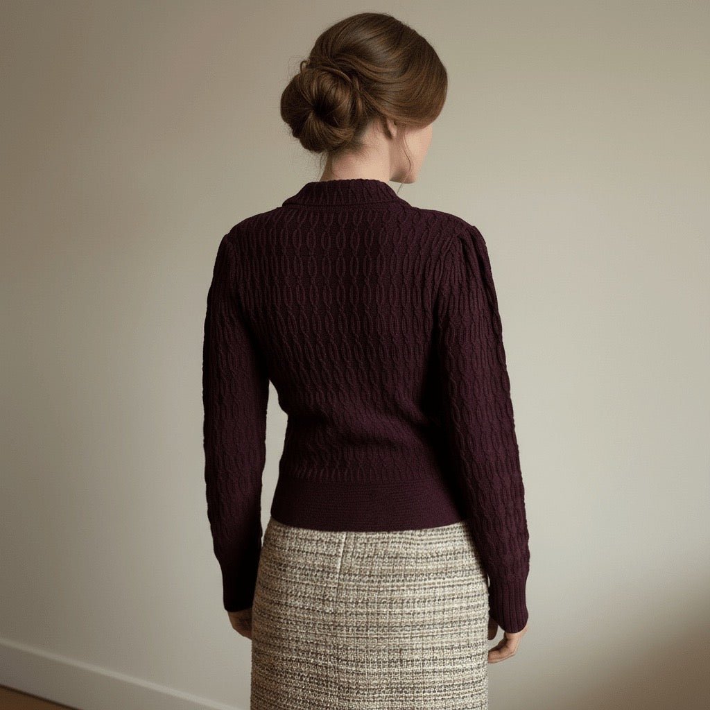 Back view of a woman wearing a dark purple plum vintage styled chunky knit cardigan