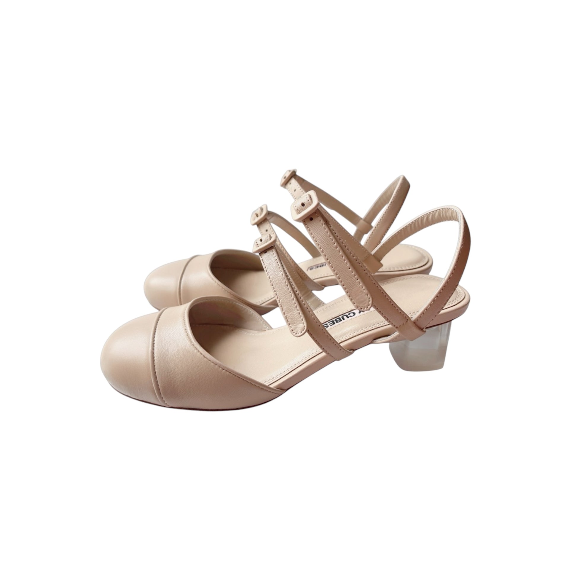 Side view of beige leather Mary Jane pumps with double buckles and crystal perspex heels