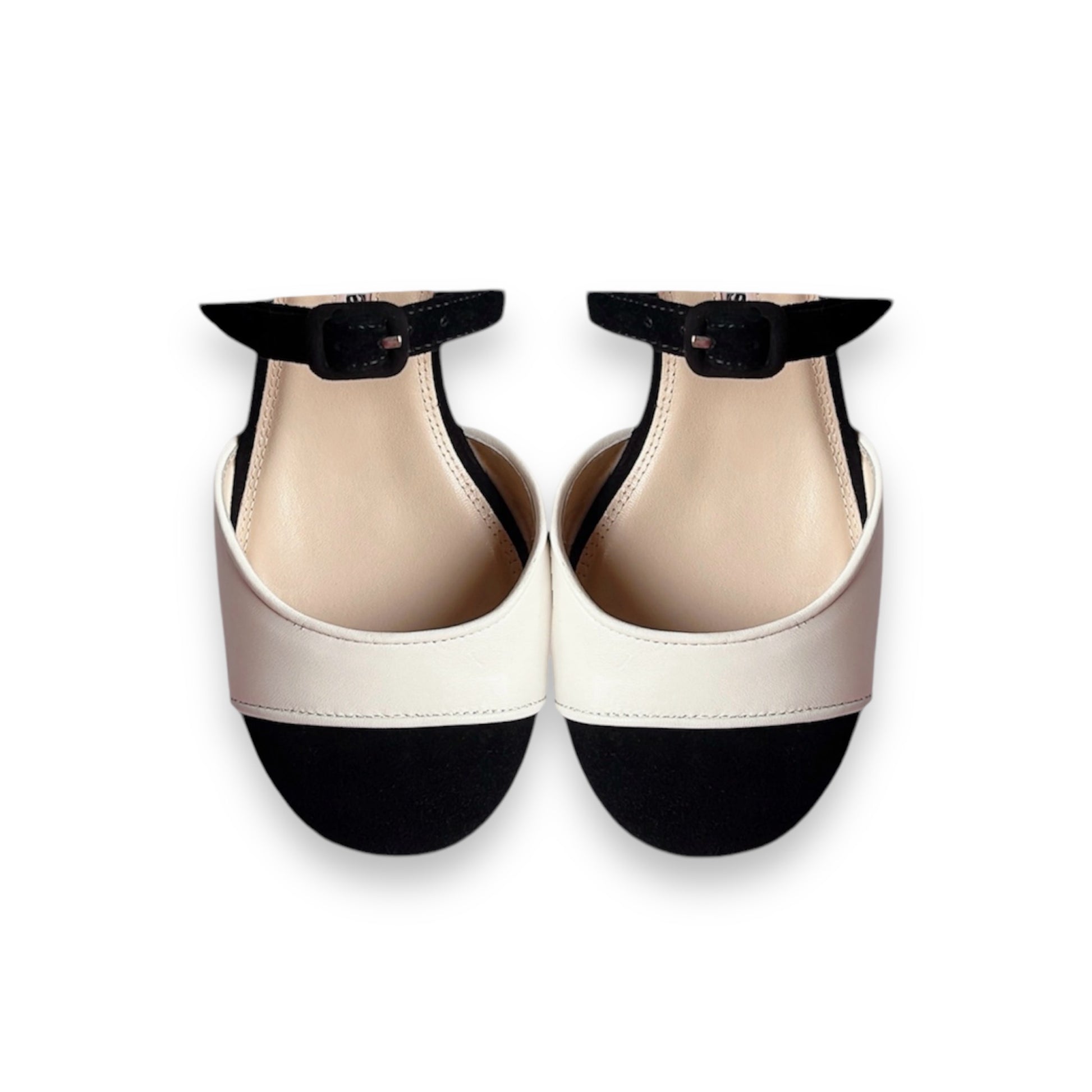 Toe box of black and cream Mary Jane pumps showing piped edging and colour block detail
