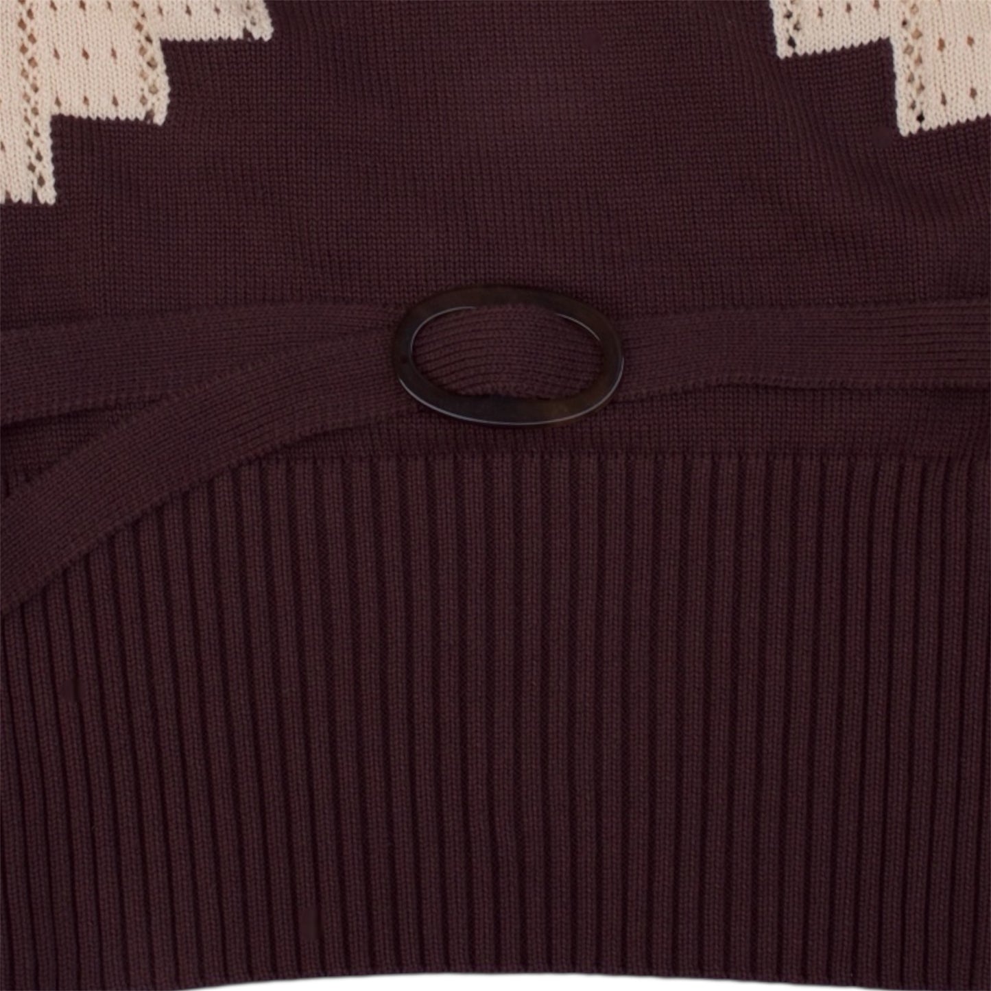 Close up of the brown and beige knitted top with brown knitted belt.