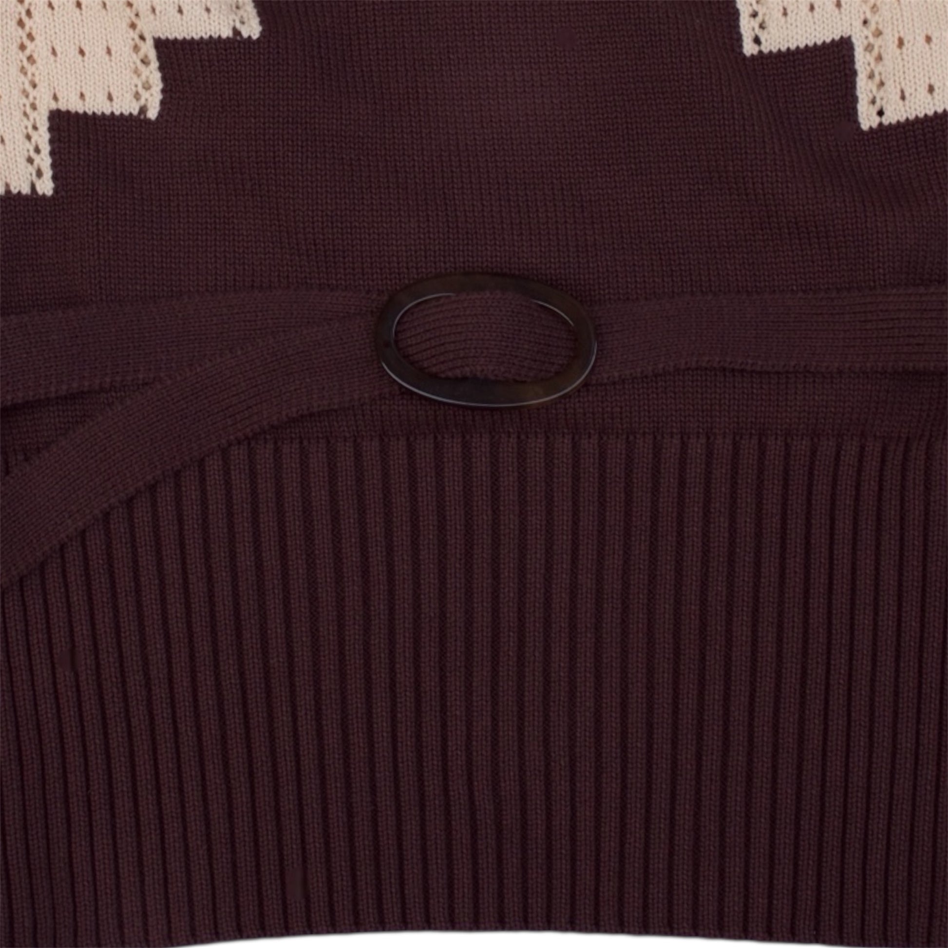 Close up of the brown and beige knitted top with brown knitted belt.