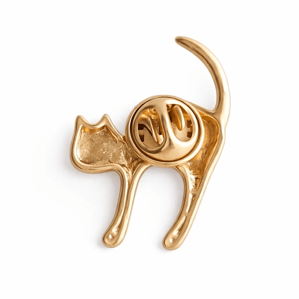 Gold cat-shaped brooch on a white background