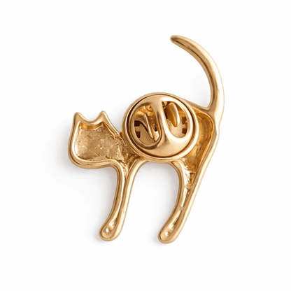 Gold cat-shaped brooch on a white background