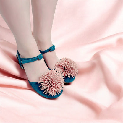 Model wearing green suede pumps with decorative pom-poms and coloured crystal heels