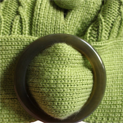 Green buckle on green knitted fabric 