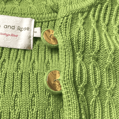 Chunky cable green cardigan with buttons close up 