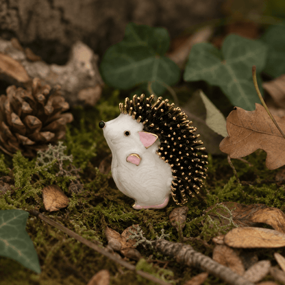 Woodland Hedgehog Enamel Brooch - front view on moss and autumn leaves