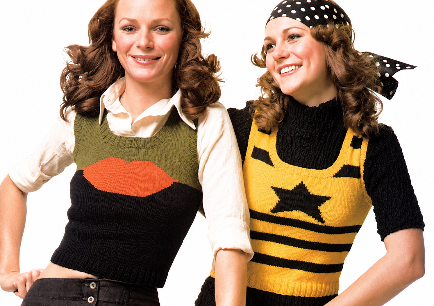 Two women wearing colorful sweater vests with lip and star designs on a white background